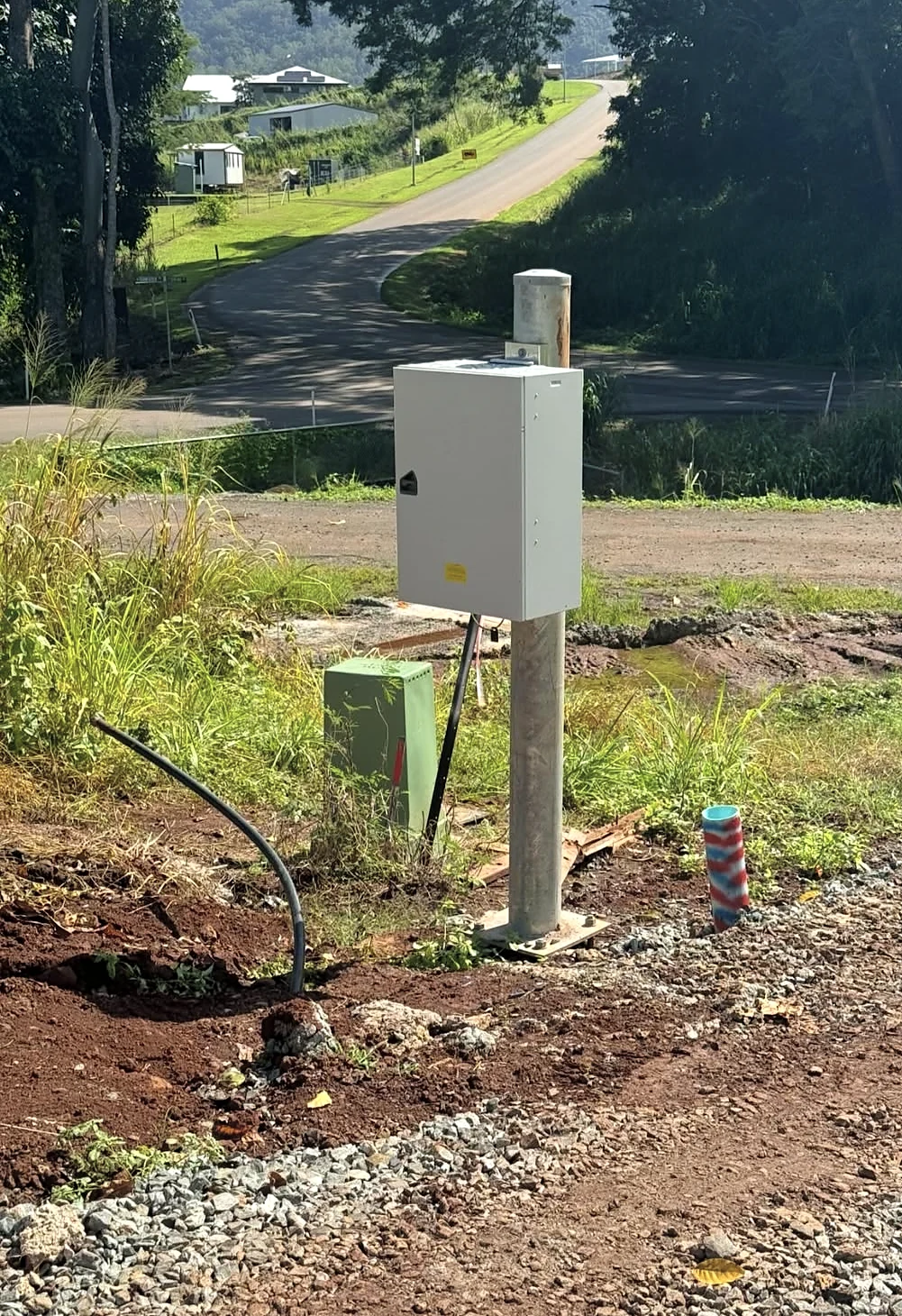 Meter board and property pole beside an underground service trench at Goldsborough